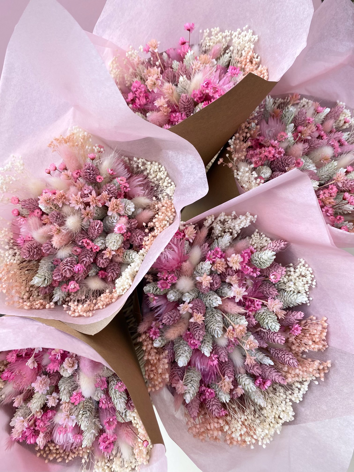 pink dried flower bouquet wrapped in pink tissue paper for wedding
