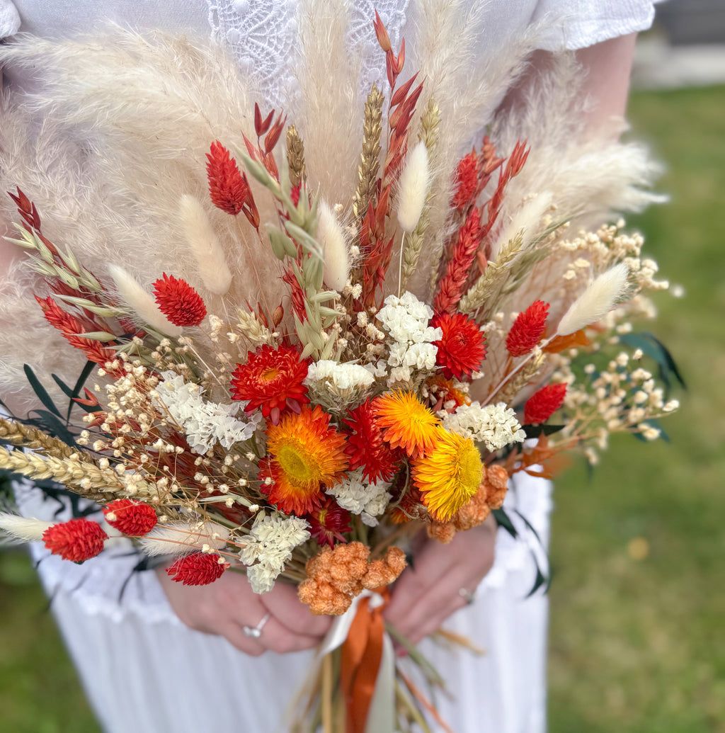 pampas grass arrangement with orange, green and white dried flowers