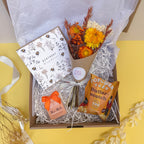 Birthday Gift box with flowers, card and popcorn on a yellow background