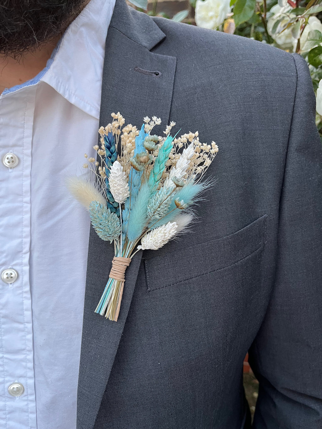 blue boutonniere with bunny tails