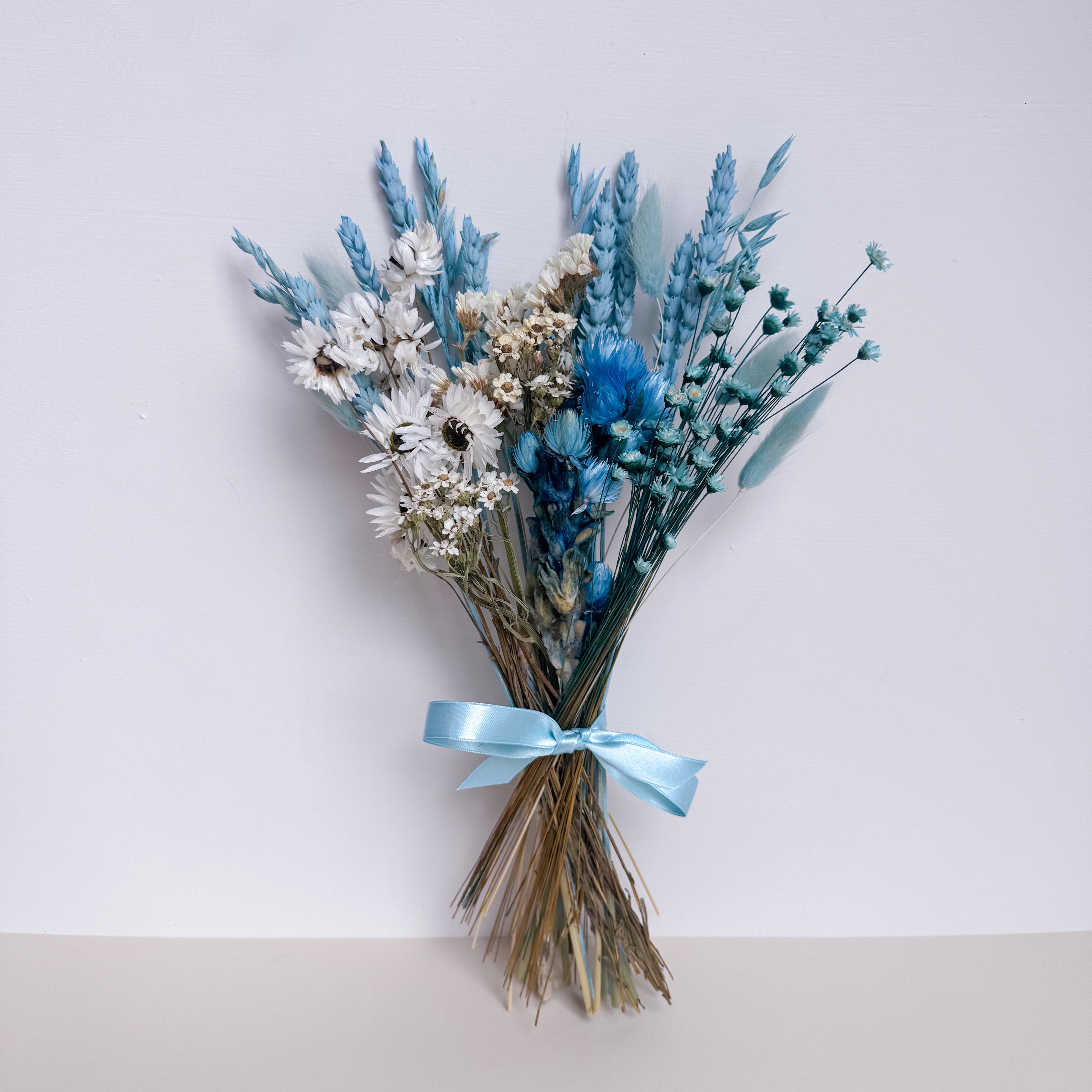 small blue dried flower bunch with blue bunny tails
