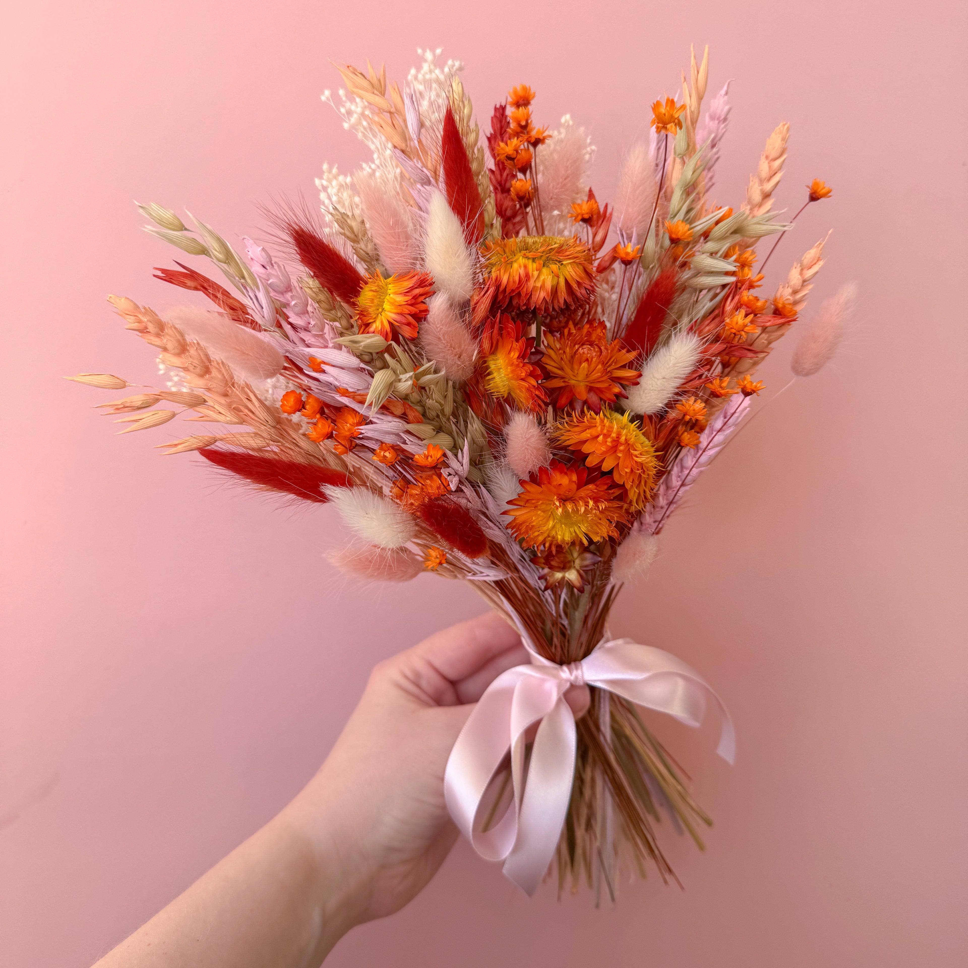 burnt orange dried strawflower arrangement with pink and white