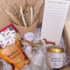 christmas gift box with flowers, popcorn, sparkling snowflake candle and christmas card