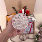 Hand holding a cinnamon spice candle with decorative label, Christmas-themed background
