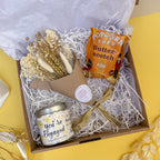 Gift box with 'You're Engaged' candle, popcorn and dried flower bunch.