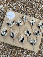 black, silver and white dried flower buttonhole