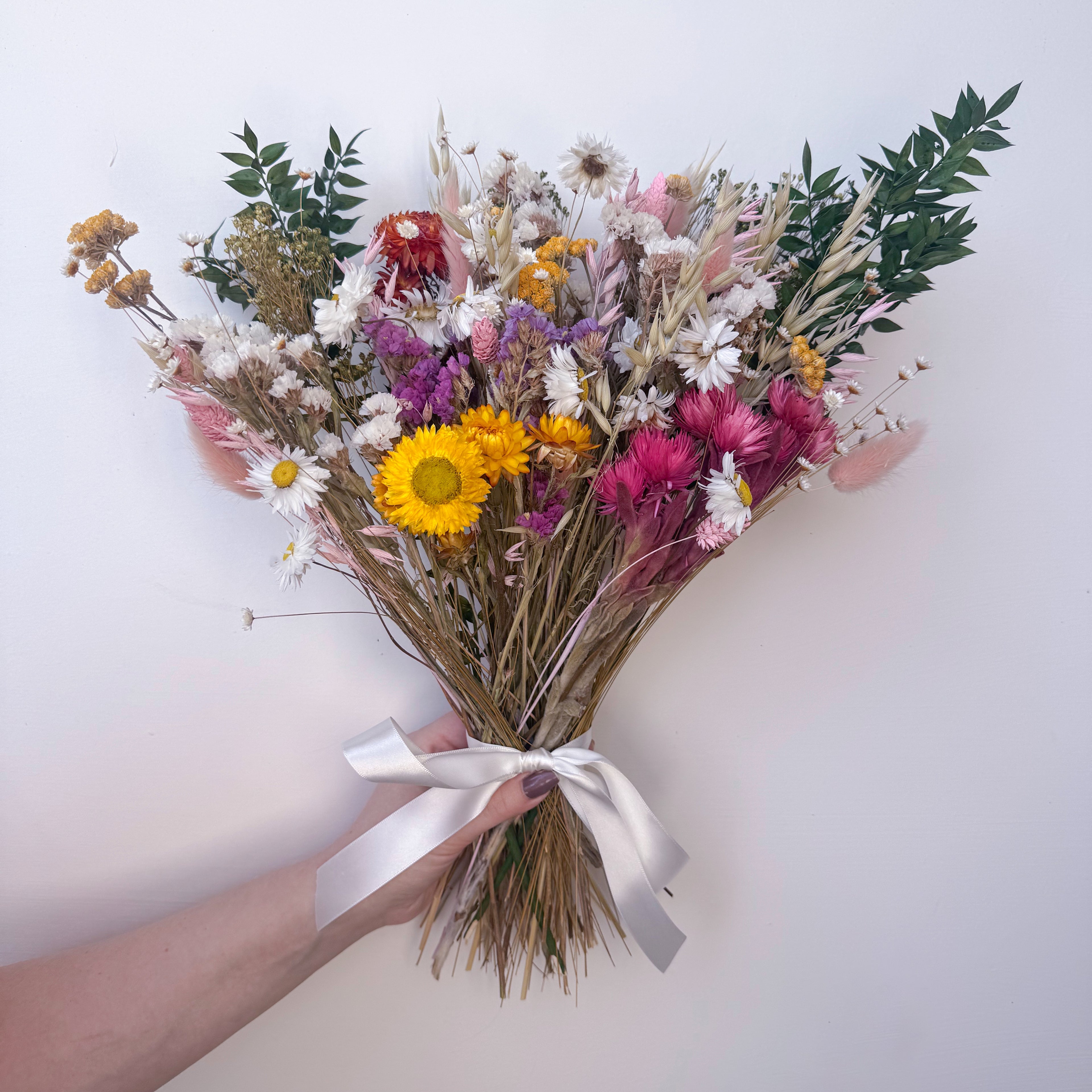colourful wildflower arrangement against a white background