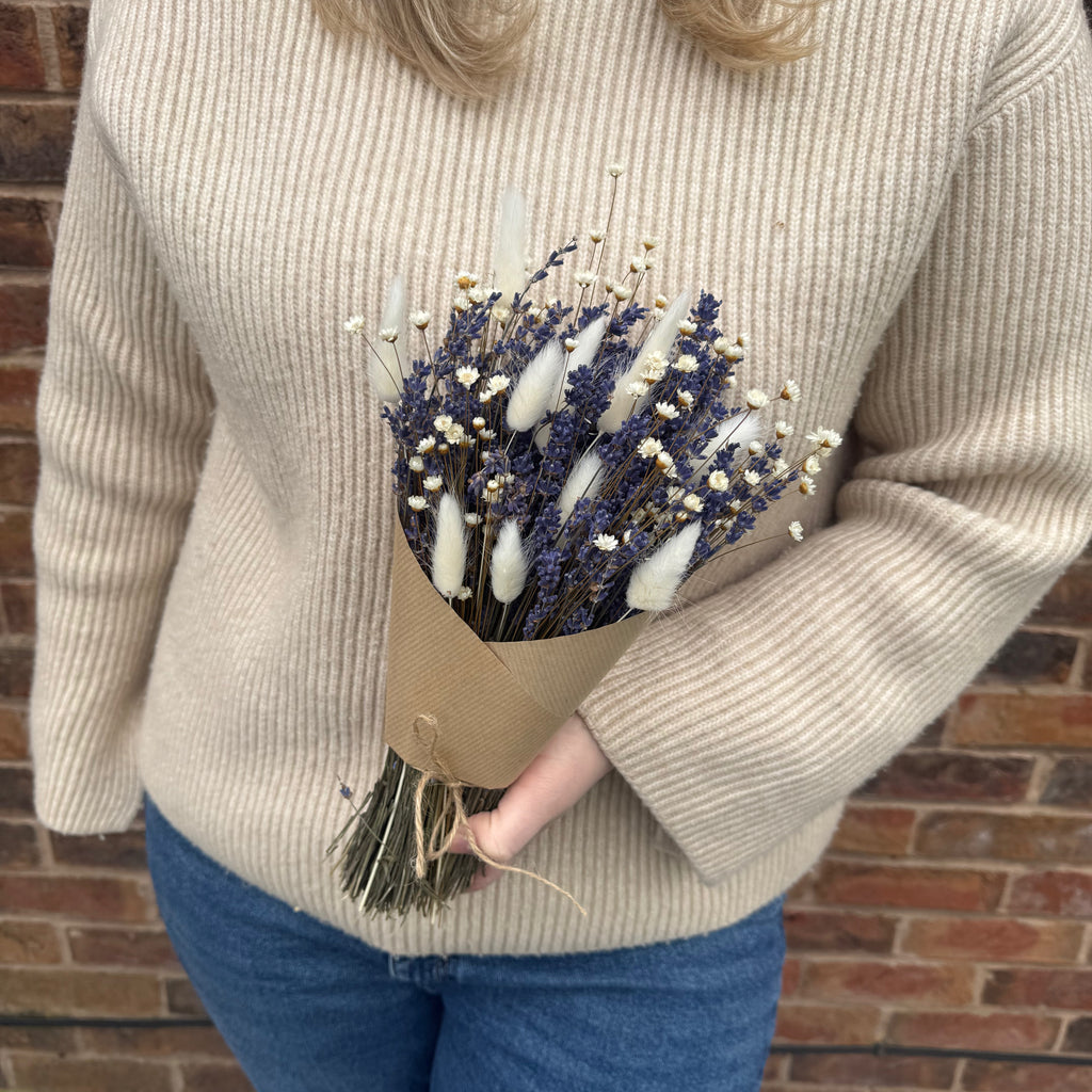 lavender bouquet being held in brown paper