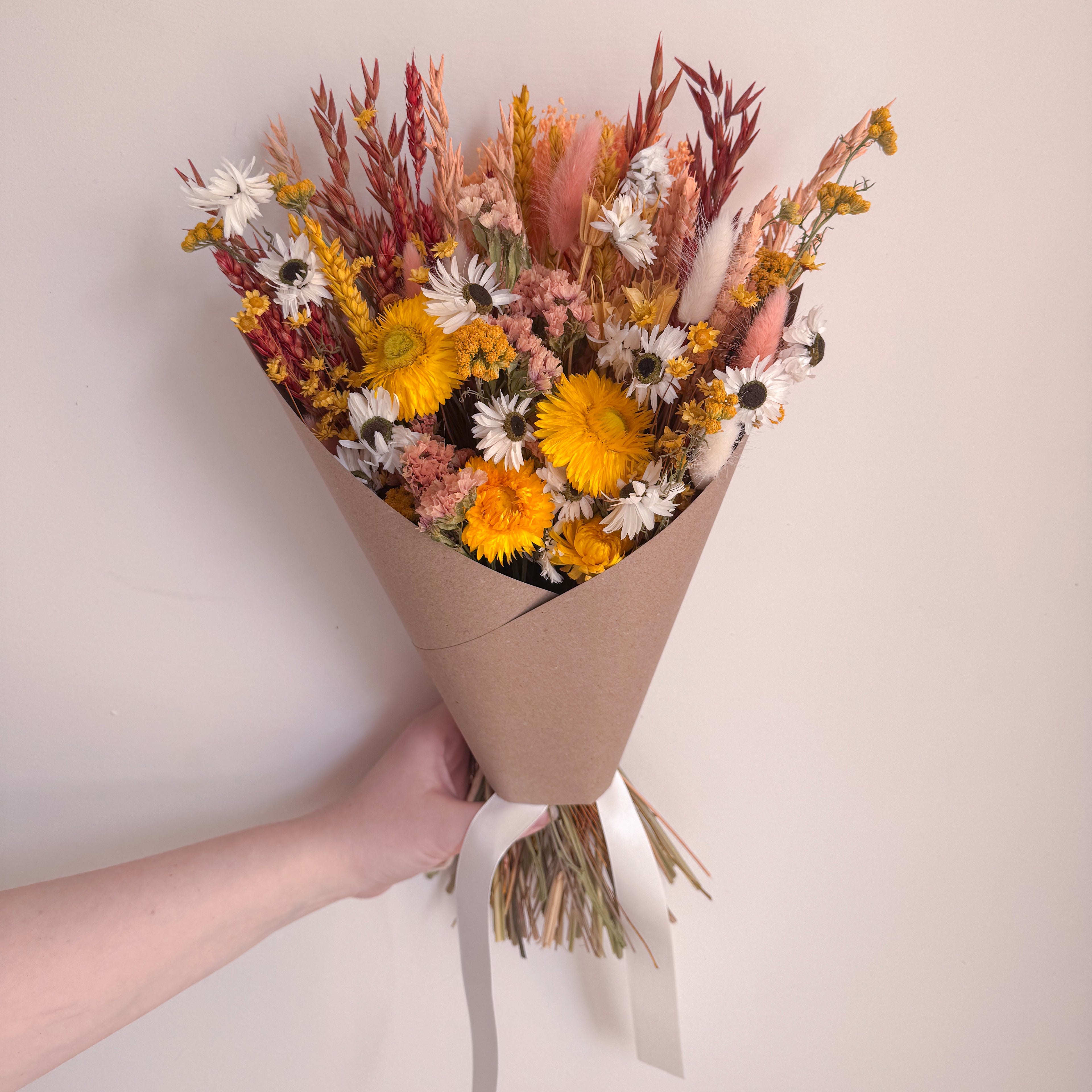 dried yellow and orange flower arrangement