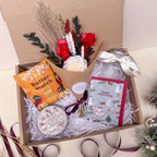 christmas gift box with dried flowers and candle