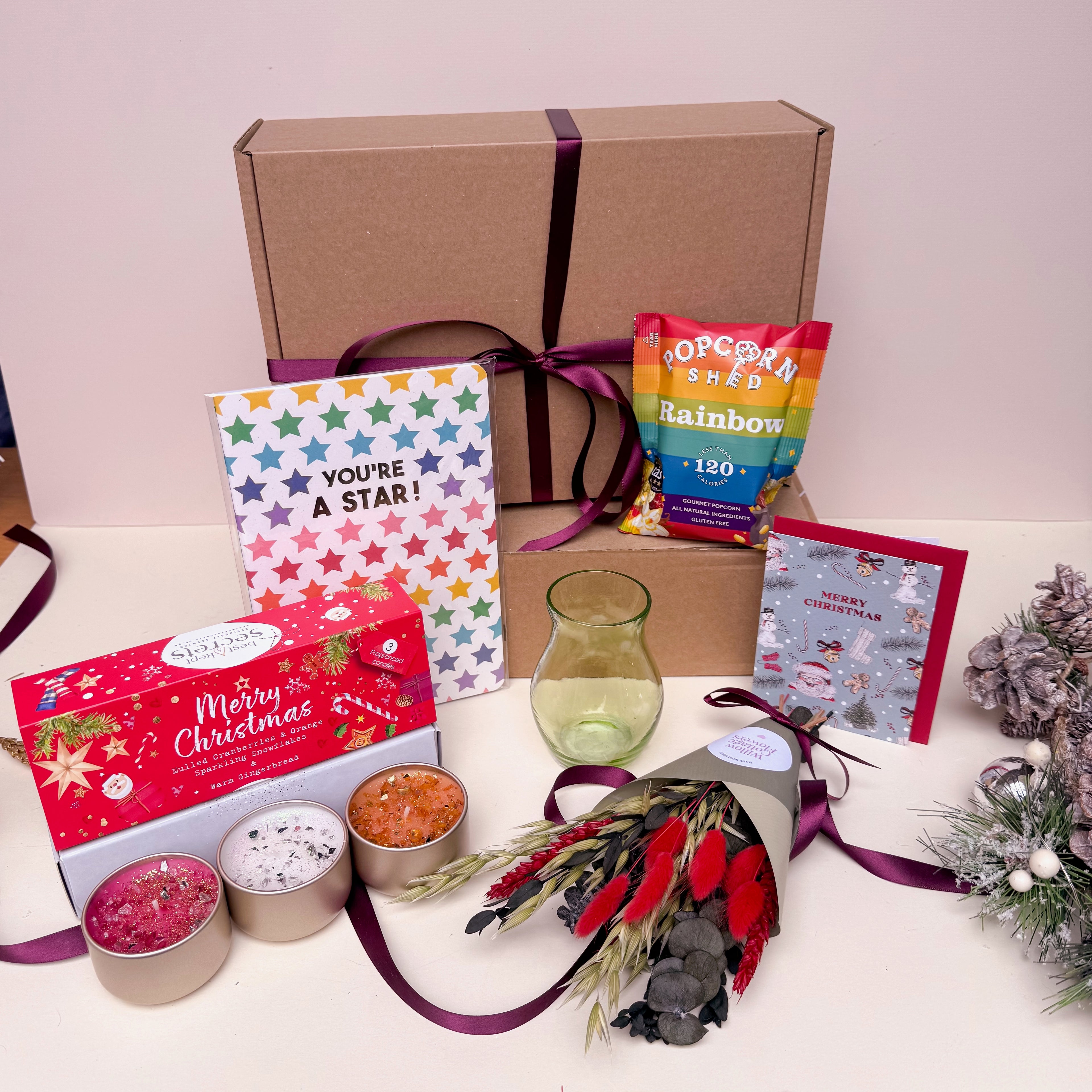 Gifting set with a card, popcorn, candles, and other items for Christmas