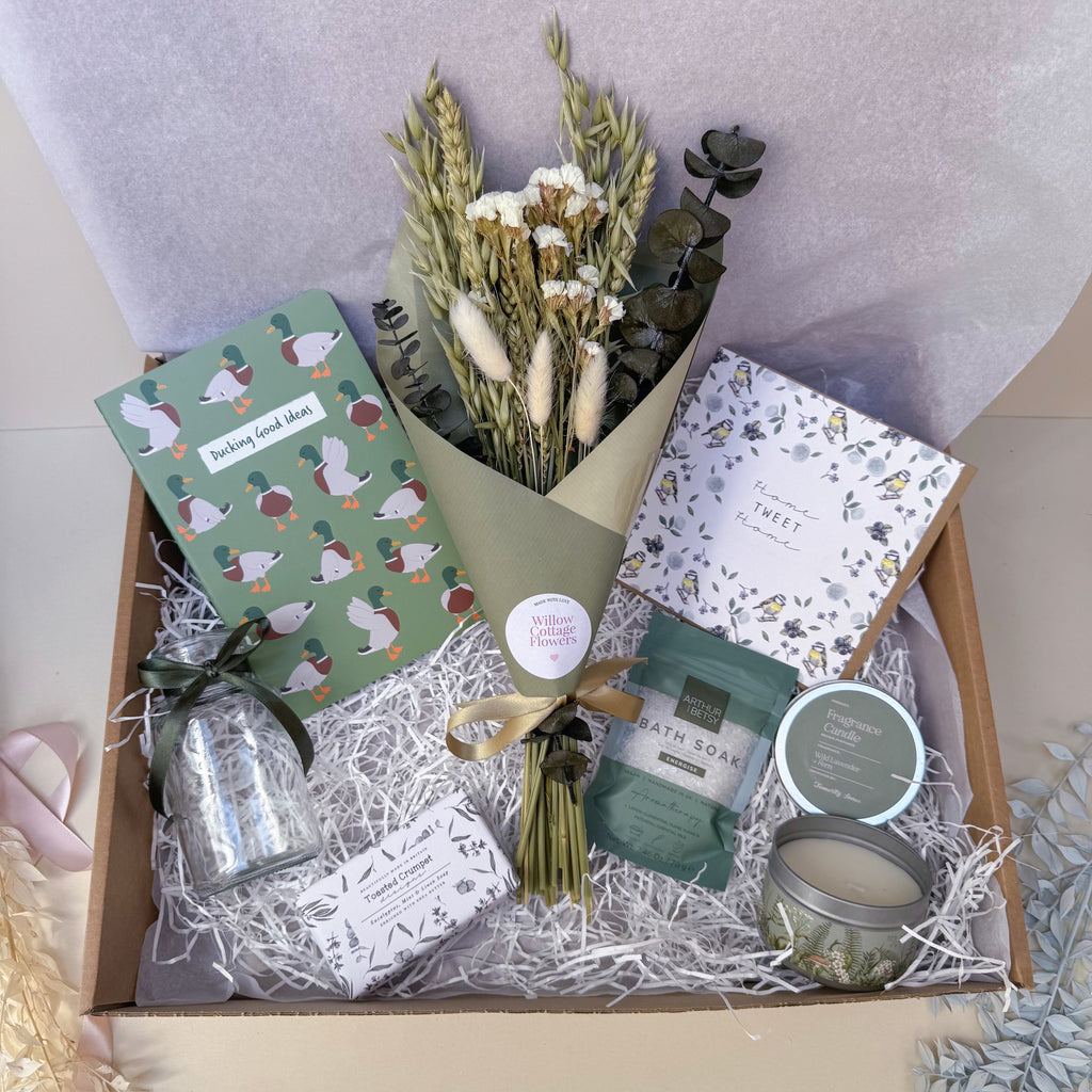housewarming gift box with notebook, dried flowers, soap, candle, bath salts and card