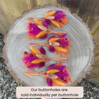 bright and colourful dried flower boutonniere in cerise and orange