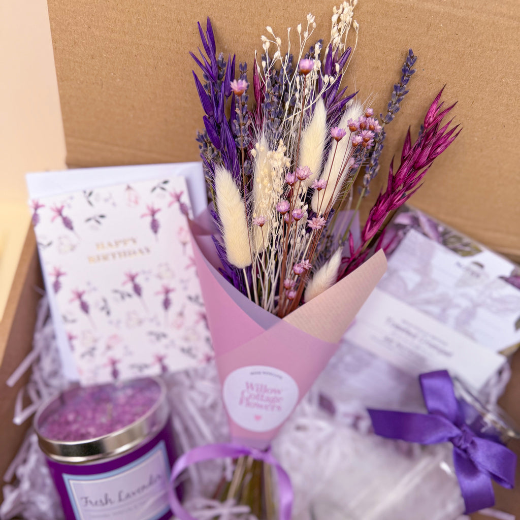 Bouquet of dried flowers with a candle and card in a gift box