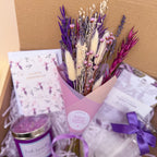 Bouquet of dried flowers with a candle and card in a gift box