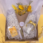 Gift set with flowers, wax melts, and a vase in a lemon theme