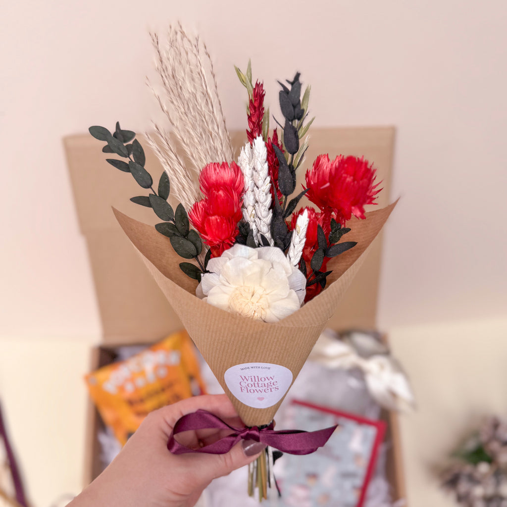 Bouquet of festive red and white flowers in brown paper wrap