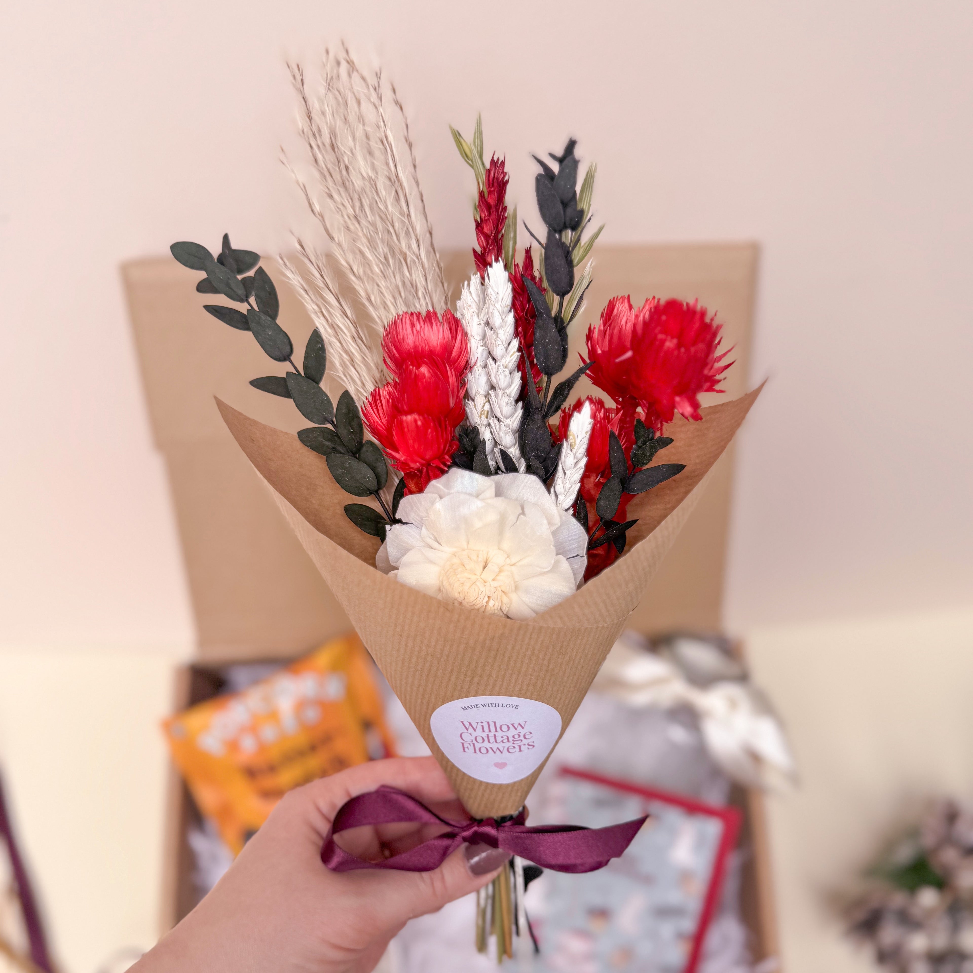 Bouquet of festive red and white flowers in brown paper wrap