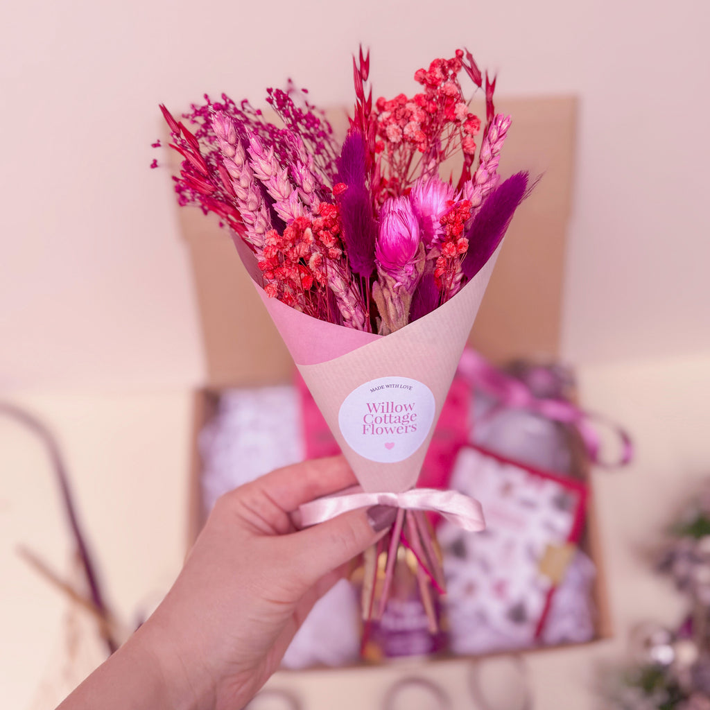 Bouquet of pink and red flowers in pink gift wrap with 'Willow Cottage Flowers' label.