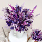 purple dried flower arrangement with oats, bunny tails, phalaris and linum displayed against a white background