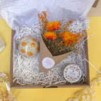 orange themed gift box with orange scented candle