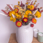spring yellow floral arrangement displayed in white vase