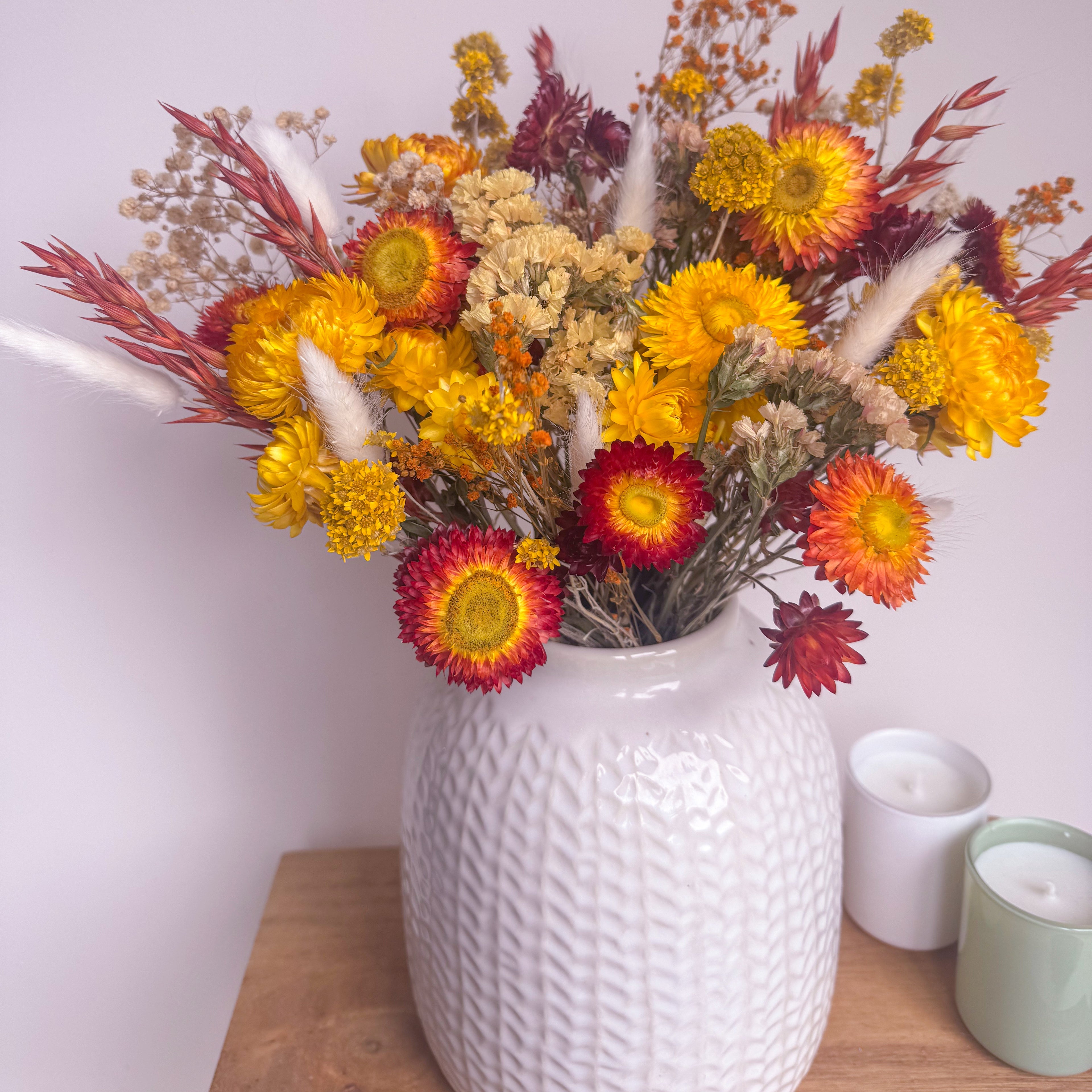 spring yellow floral arrangement displayed in white vase