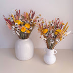 burnt orange dried flower arrangement with white daisies