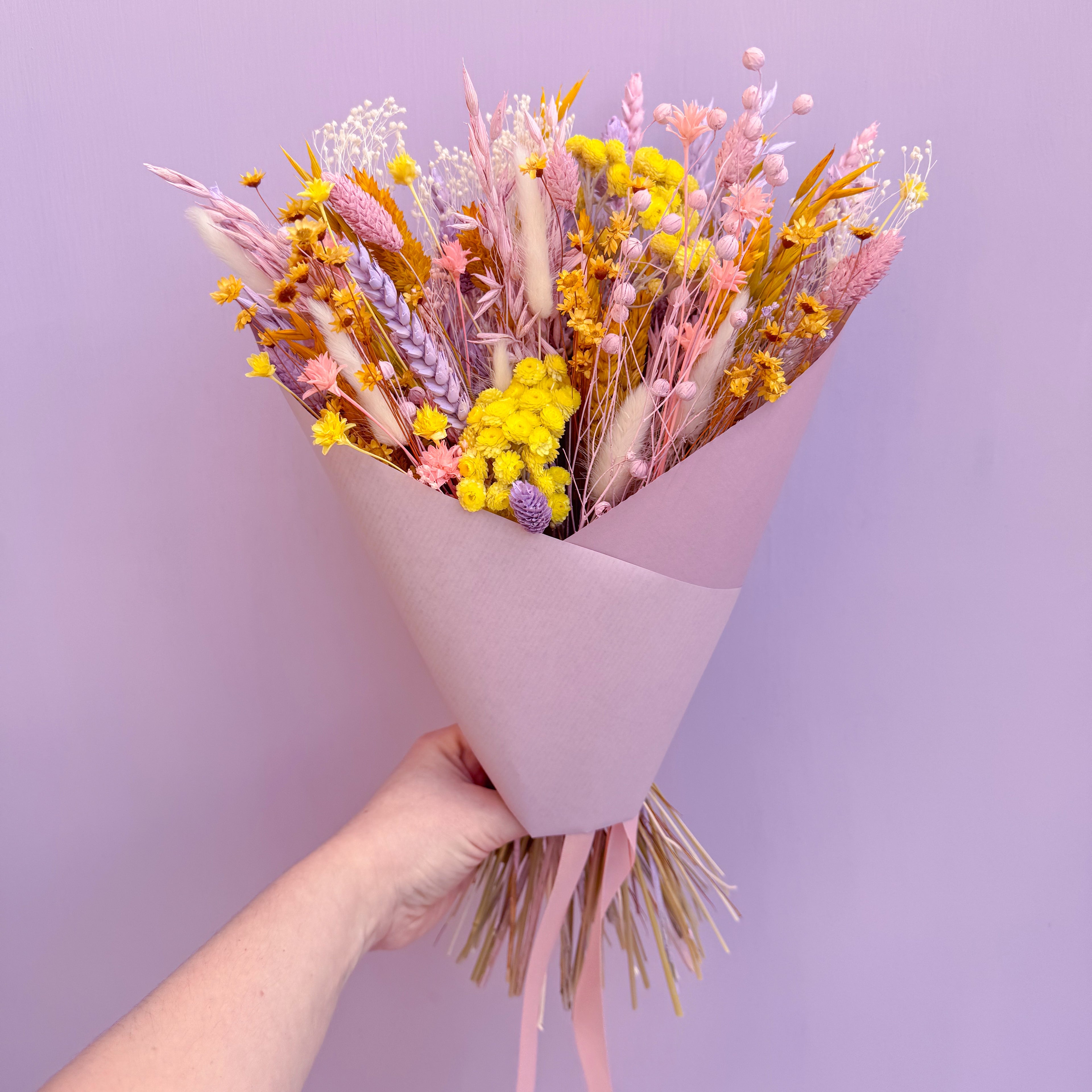 pink, yellow and lilac dried flower arrangement