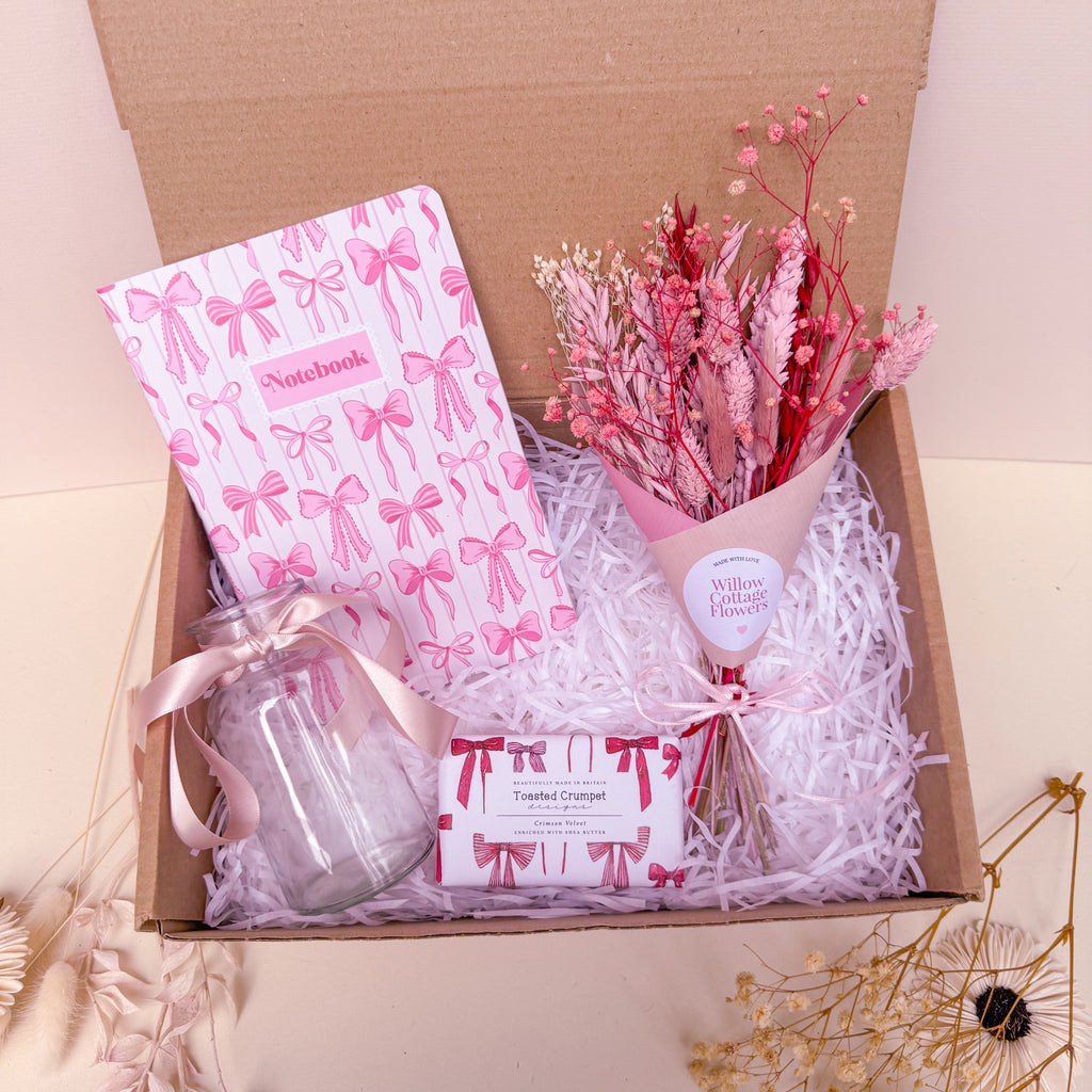 gift set with pink bow theme including notebook. dried flowers and vase