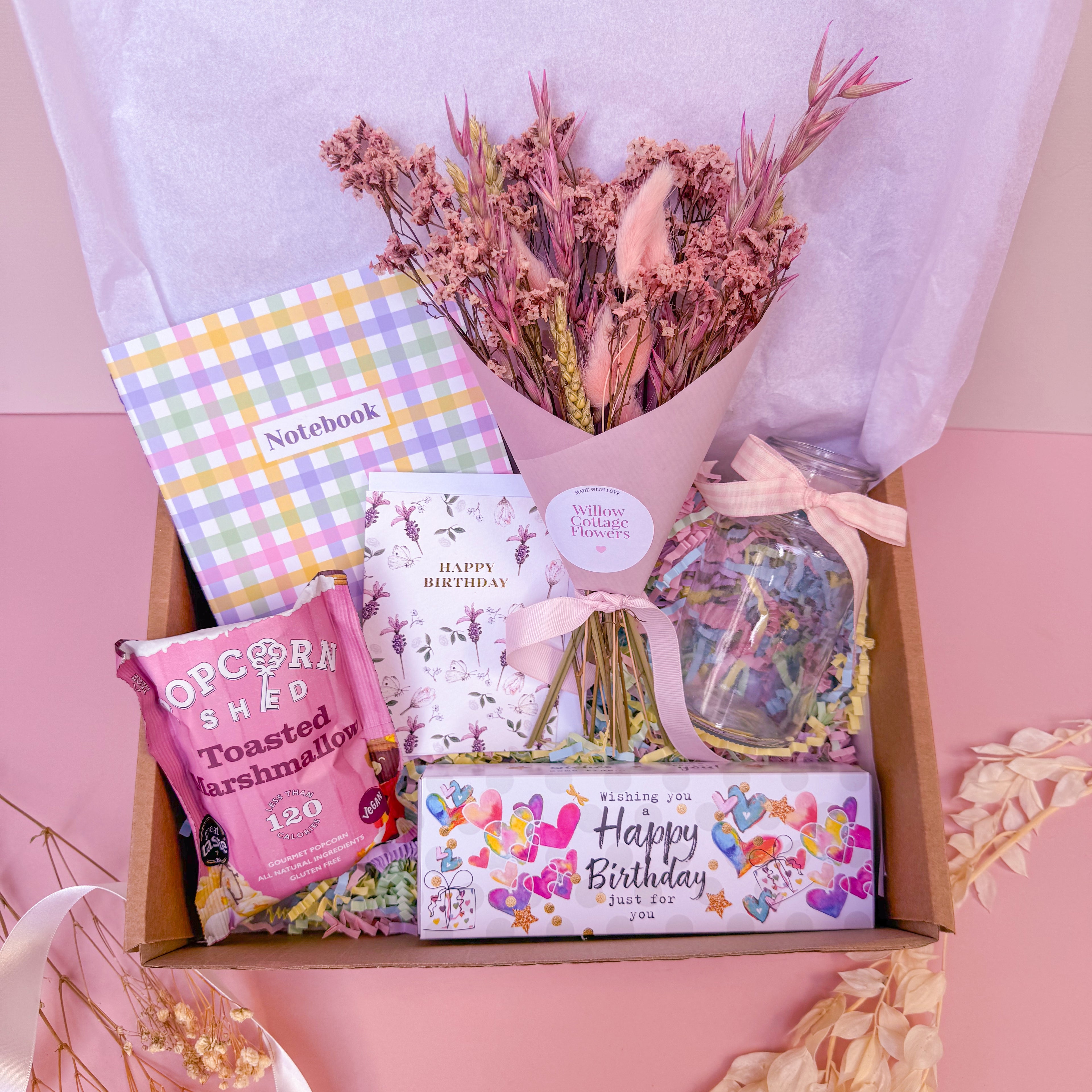 happy birthday gift hamper with birthday candles, birthday card and pastel dry flower bunch