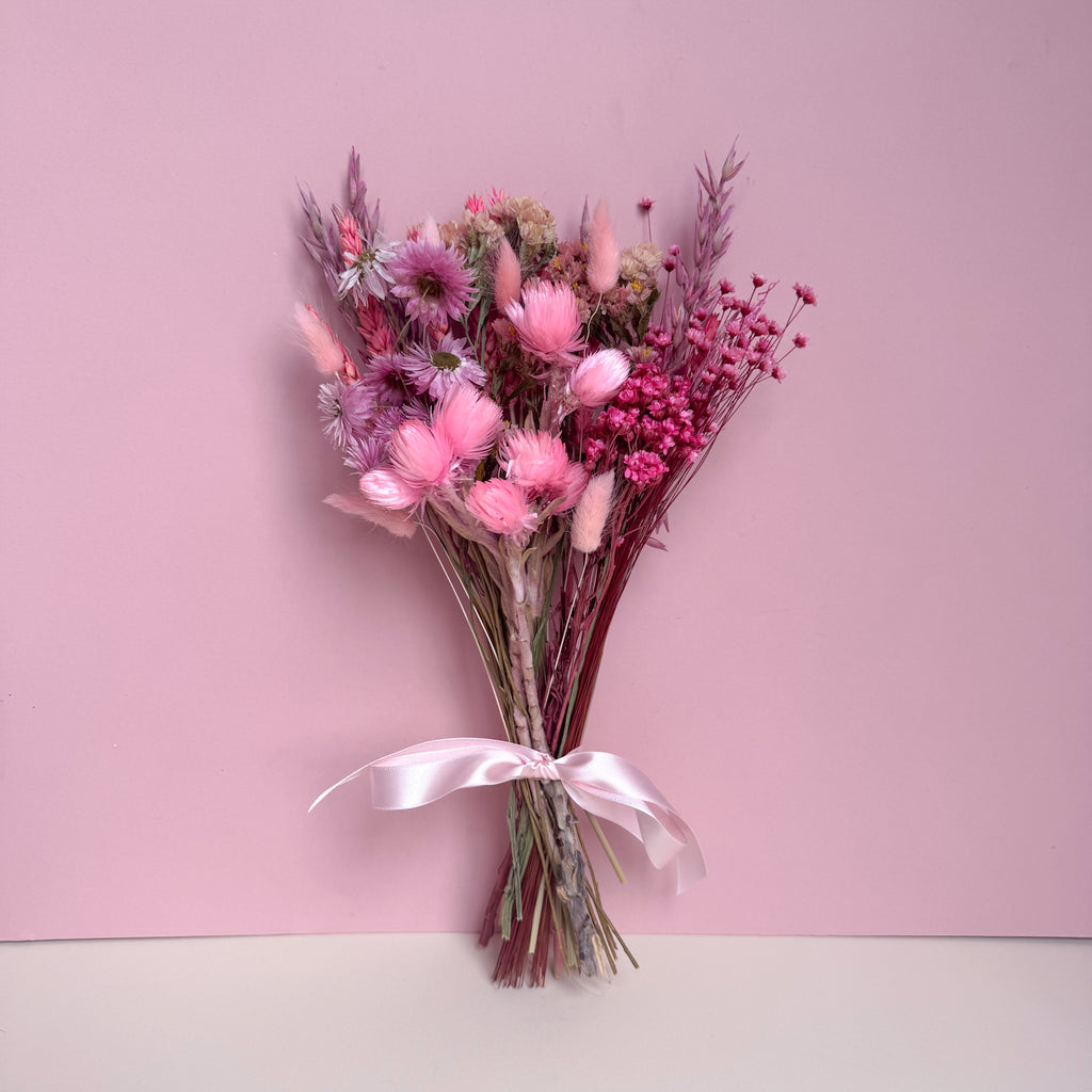 small bouquet of pink dried flowers with pink daisies