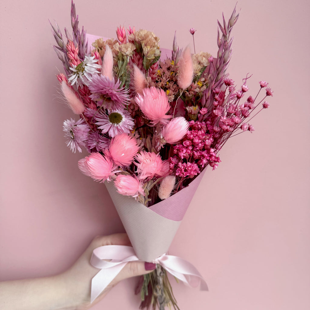 pink wildflower bouquet with pink gift wrap