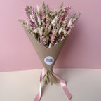 a pink delphinium dried flower arrangement with sage green accents
