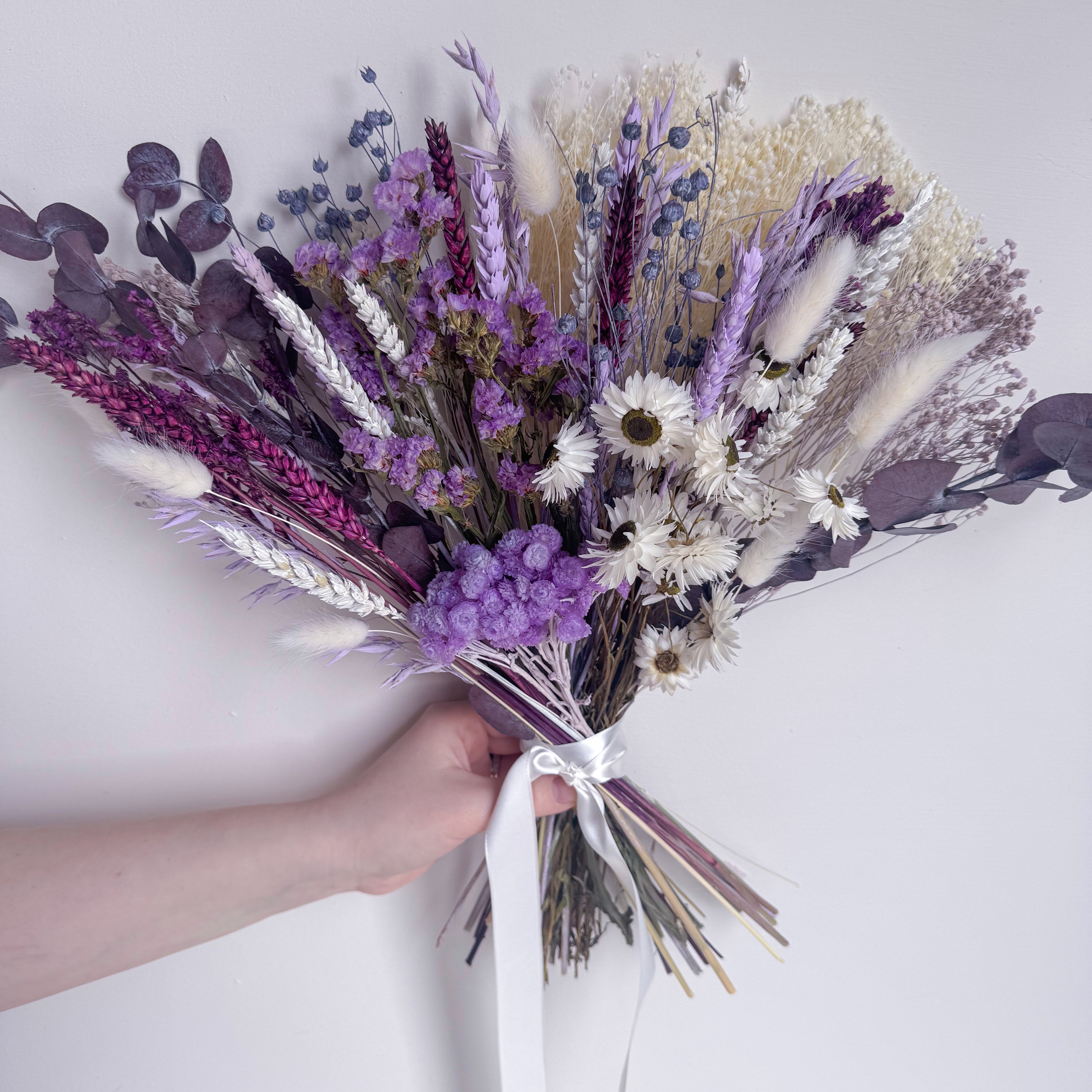 bouquet of dried flowers in purple, plum, white and lilac