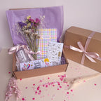 Gift box with flowers, notebook, and other items for mothers day