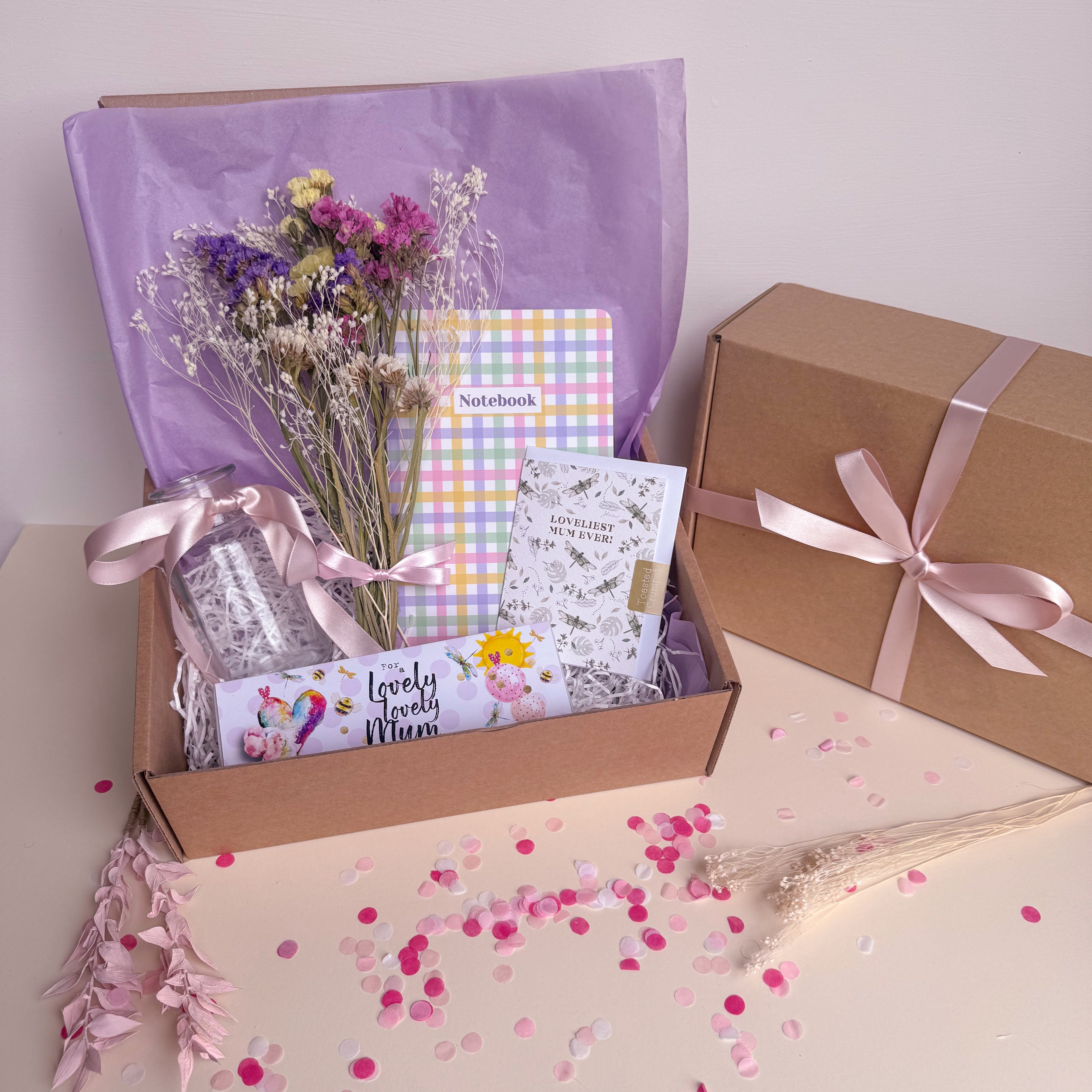 Gift box with flowers, notebook, and other items for mothers day
