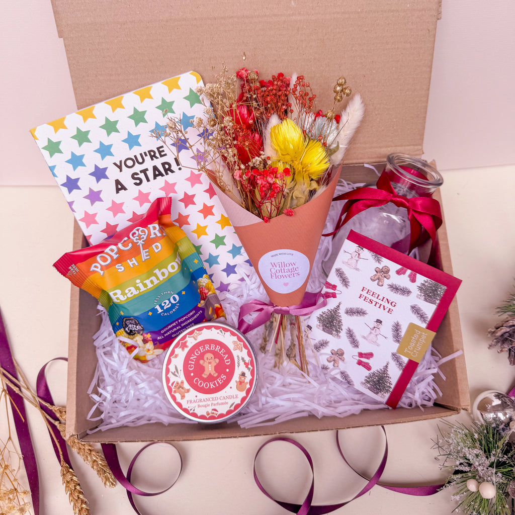 rainbow gift box with dried flowers and festive candle