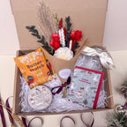 festive gift box with flowers, popcorn, candle and vase