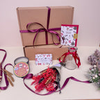 Gift box with a candle and other christmas treats with dried flowers.