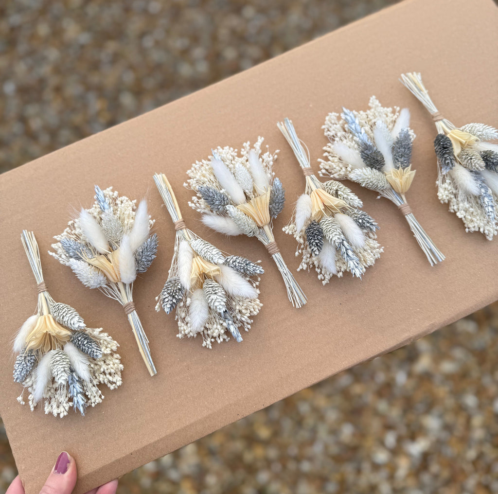 silver and white dried flower buttonhole pin