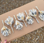 silver and white dried flower buttonhole pin