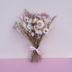 small flower girl dried flower bouquet with daisies, strawflowers, oats and wheat in pink, green and white tones.