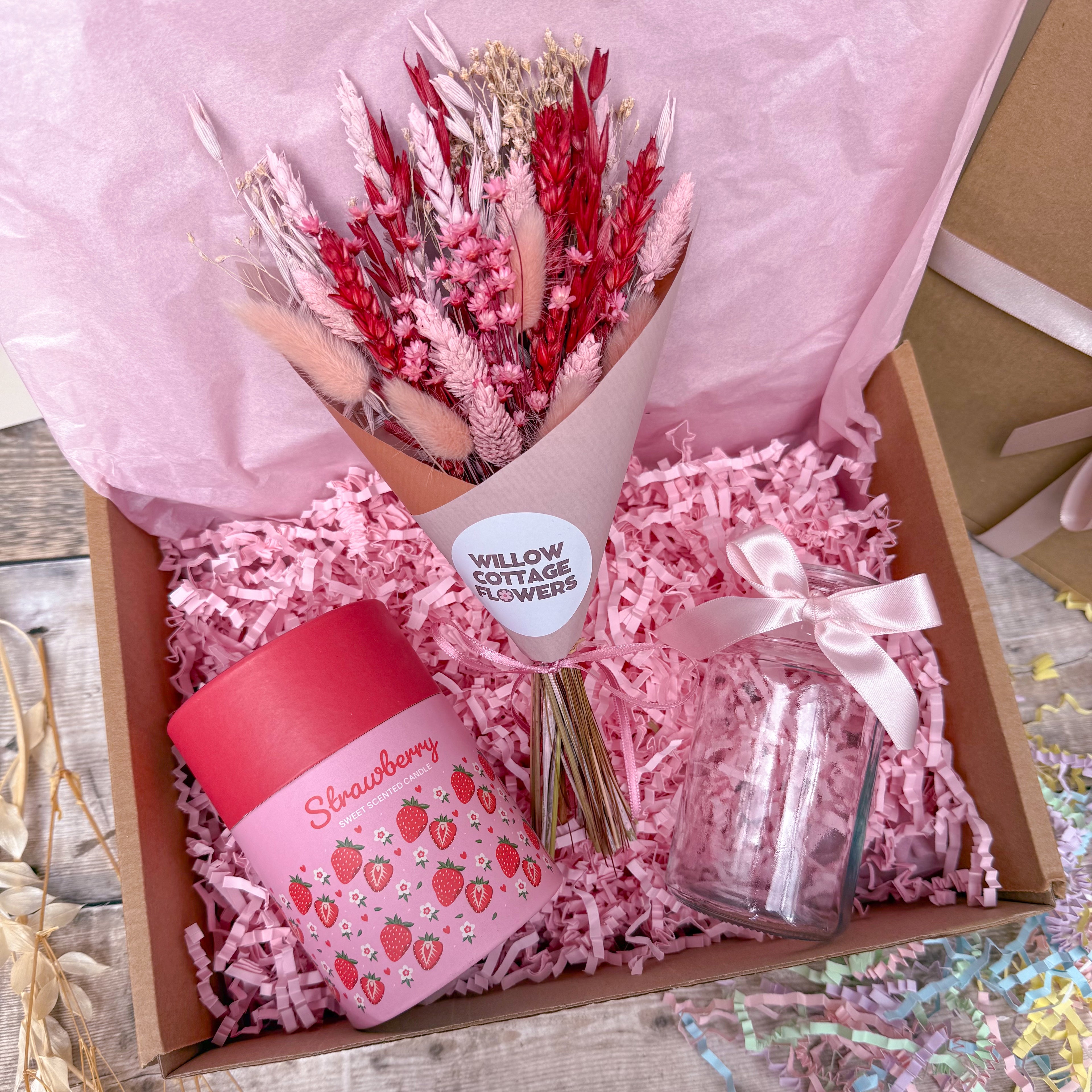 a strawberry themed gift box with dried flowers, glass vase and strawberry scented candle