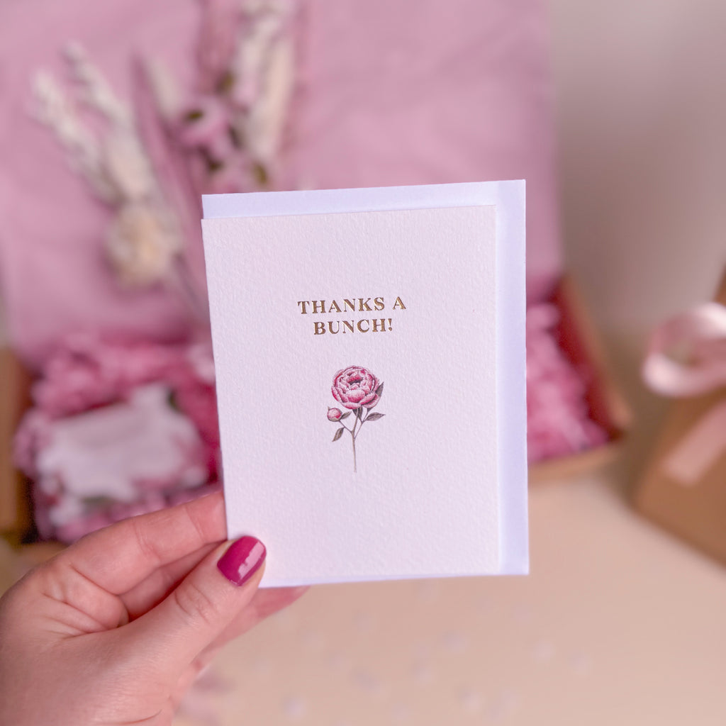 greetings card with 'thanks a bunch' text and pink peony graphic