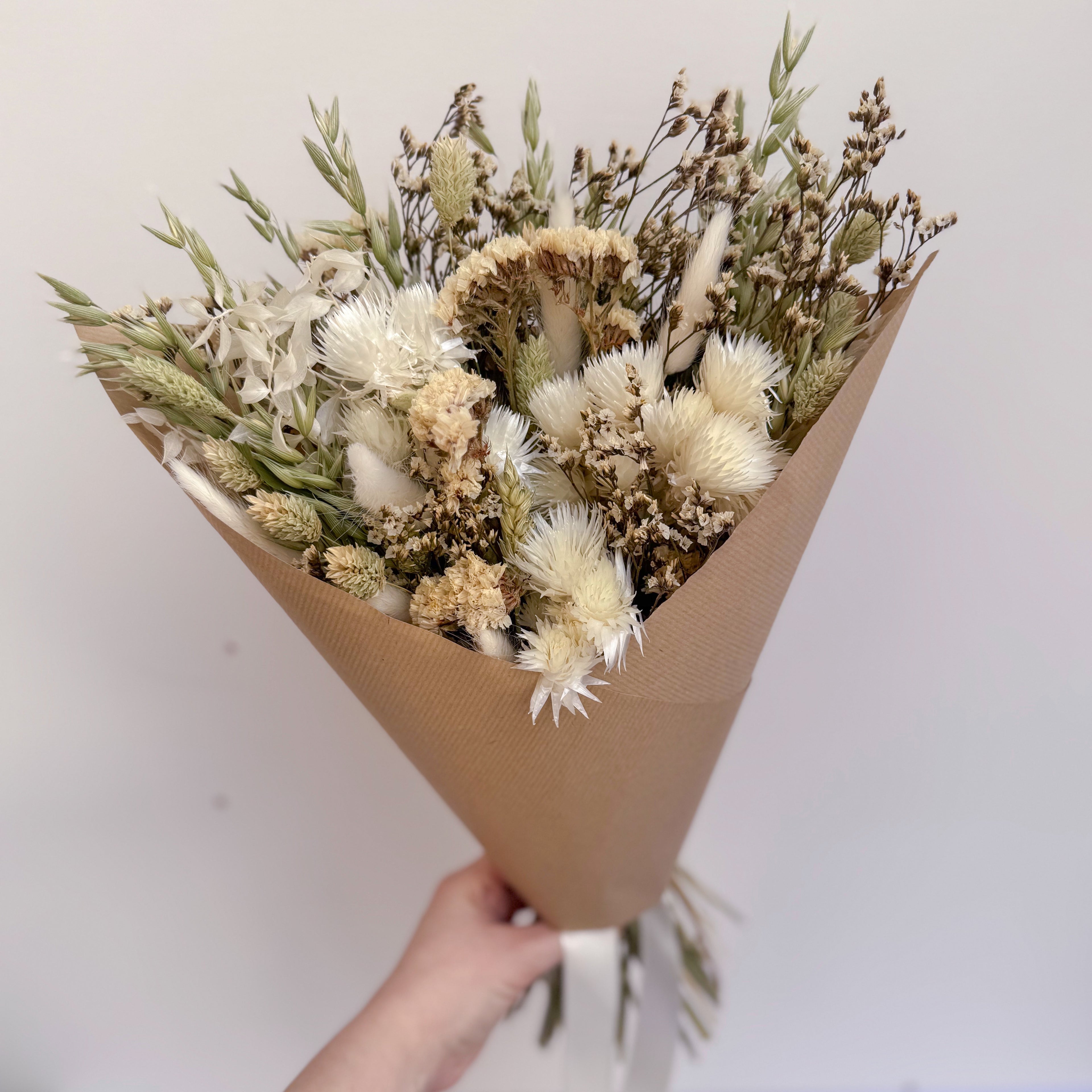 luxury white dried flower bouquet with brown paper gift wrap