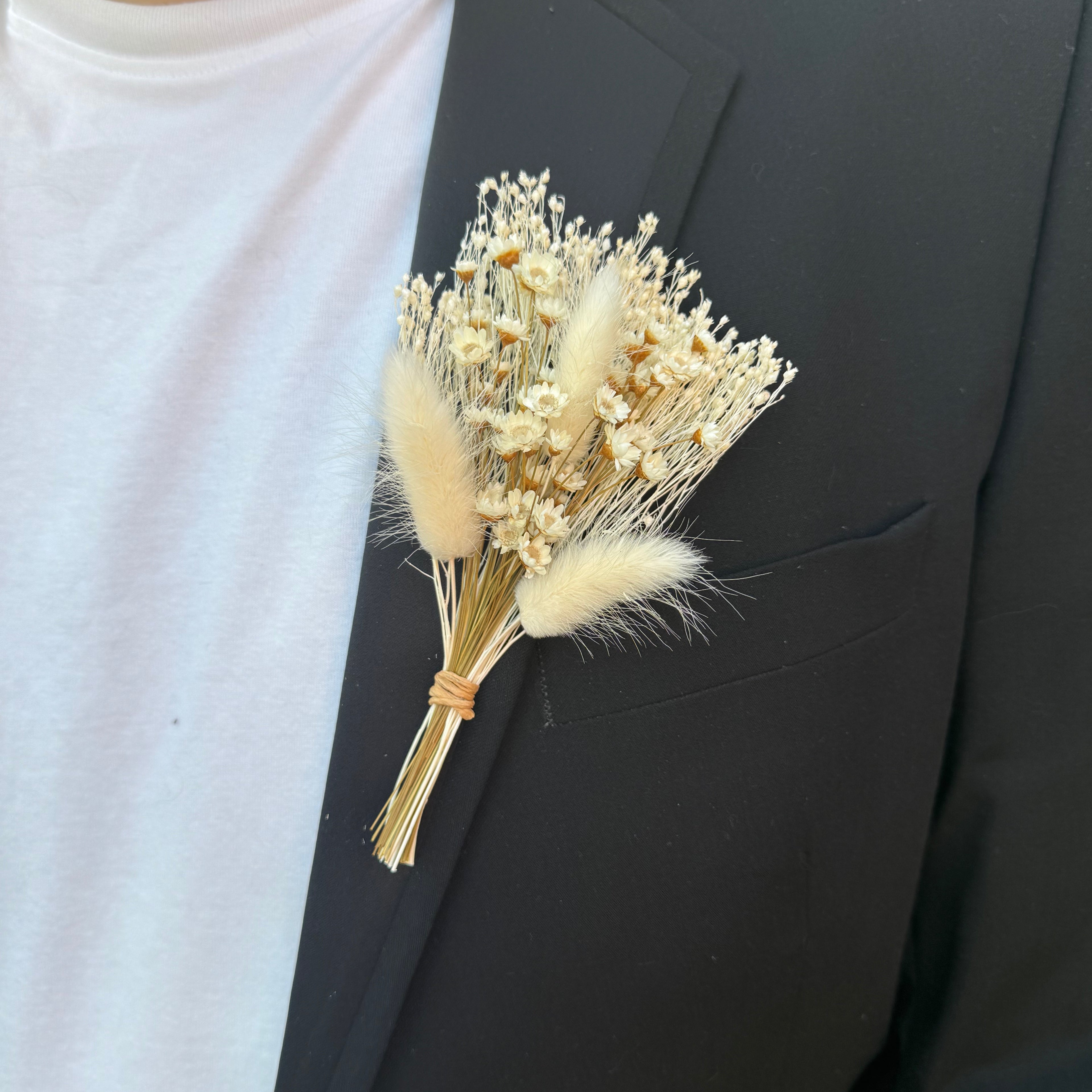 white dried flower buttonhole with white bunny tails