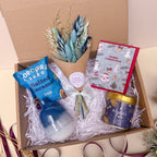 blue christmas gift box with dried flowers, vase and candle