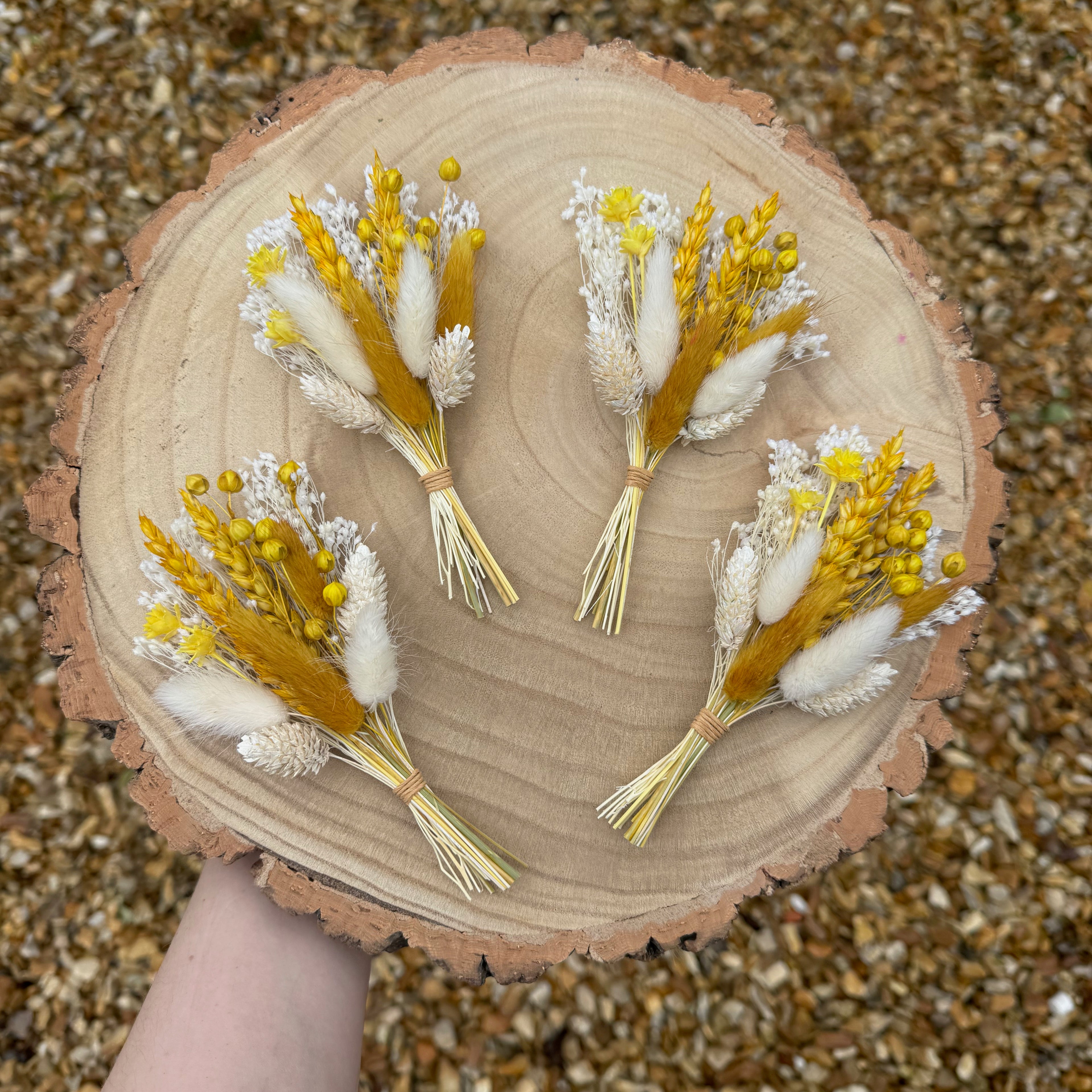 spring yellow dried flower buttonhole on wood background