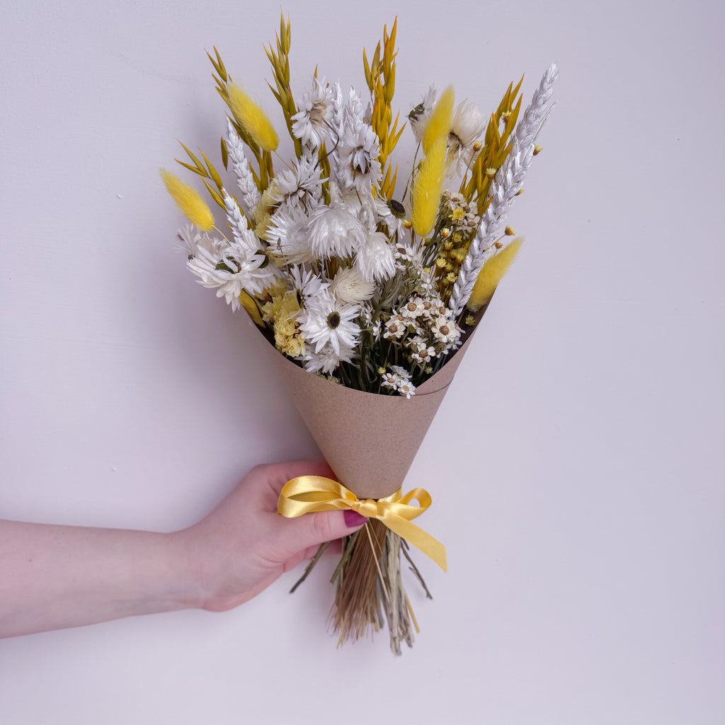 small yellow dried flower arrangement with daisies